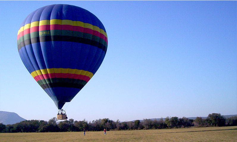 A hot air balloon coming in to land after a successful flight.